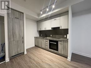 Toronto (Banbury-Don Mills) condo for rent - A kitchen with wooden cabinets and a stainless steel oven.