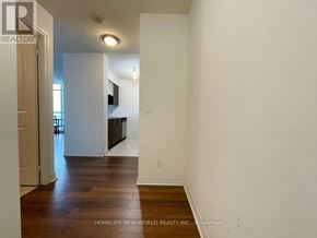 Toronto (Bendale) condo for rent - A white hallway with wood flooring and a door on the left.