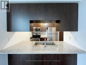 Toronto (Bendale) condo for rent - A modern kitchen with a granite countertop and stainless steel appliances.