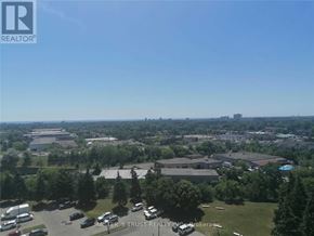 Mississauga (Mississauga Valleys) condo for rent - A bird's eye view of a real estate company's property with a parking lot and buildings.