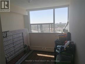 Mississauga (Mississauga Valleys) condo for rent - A room with a window overlooking a cityscape and a balcony with a metal railing.
