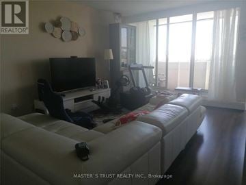 Mississauga (Mississauga Valleys) condo for rent - A living room with a white couch and a television.