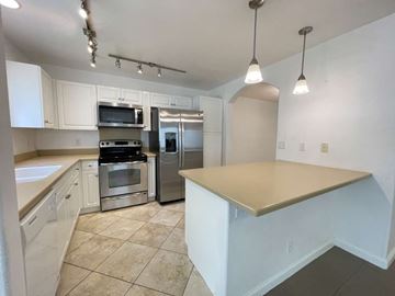 Waianae apartment for rent - A kitchen with white cabinets and a large island.