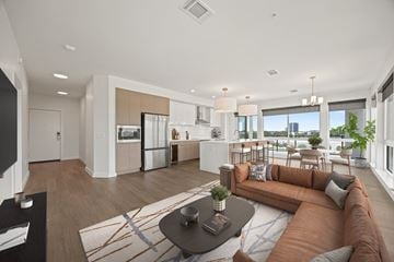 Arlington apartment for rent - A modern living room with a brown sofa and a coffee table.