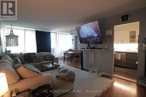 Toronto (Victoria Village) condo for rent - A living room with a couch, a coffee table, and a television.
