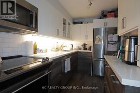 Toronto (Victoria Village) condo for rent - A kitchen with a stove, microwave, and refrigerator.