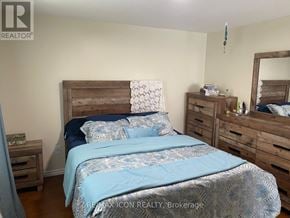 London South (South X) apartment for rent - A bedroom with a bed, nightstand, and mirror.