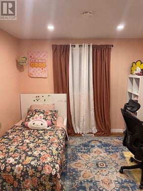 London South (South X) apartment for rent - A bedroom with a floral bedspread and a pink pillow with a bunny design.