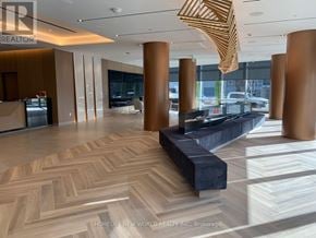 Toronto (Agincourt South-Malvern West) condo for rent - A large, open space with a herringbone patterned floor and a reception desk.