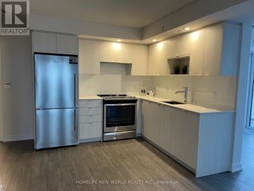 Toronto (Agincourt South-Malvern West) condo for rent - A modern kitchen with white cabinets and stainless steel appliances.