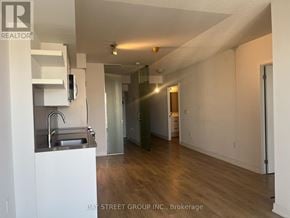 Toronto (Church-Yonge Corridor) condo for rent - A kitchen with white cabinets and a sink.