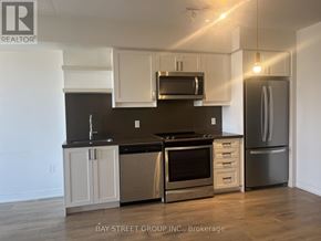Toronto (Church-Yonge Corridor) condo for rent - A modern kitchen with a stainless steel refrigerator and oven.