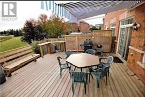 Brampton (Madoc) apartment for rent - A wooden deck with a table and chairs.