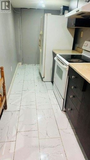 Brampton (Madoc) apartment for rent - A kitchen with a white tile floor and a white refrigerator.