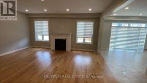 Hamilton (Meadowlands) apartment for rent - A spacious room with wooden flooring and a fireplace is on the market with Kingsway Real Estate.