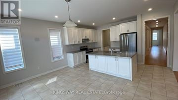 Hamilton (Meadowlands) apartment for rent - A spacious kitchen with white cabinets and a central island.