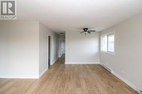 Peterborough (Town Ward 3) triplex for rent - A room with a ceiling fan and wooden flooring.