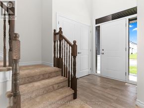 Ottawa apartment for rent - A wooden staircase with a carpeted runner leads to a white door.