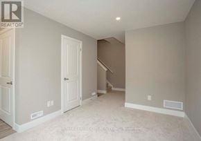London South (South U) townhouse for rent - A spacious room with a staircase in the background.