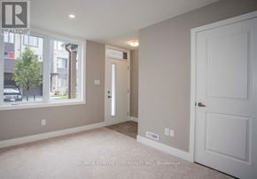 London South (South U) townhouse for rent - A room with a white door and a window with a view of a street.