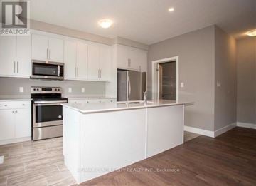 London South (South U) townhouse for rent - A kitchen with white cabinets and a stainless steel oven.