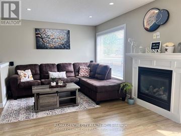 London North (North I) apartment for rent - A living room with a brown couch and a fireplace.