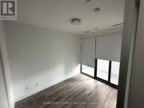 Toronto (Church-Yonge Corridor) condo for rent - A room with wooden flooring and a sliding glass door.
