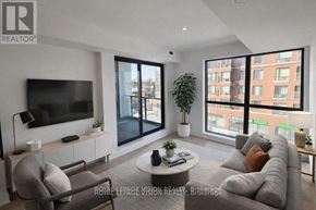 Toronto (Englemount-Lawrence) condo for rent - A living room with a grey sofa, a television, and a coffee table.