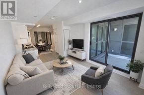 Toronto (Englemount-Lawrence) condo for rent - A living room with a grey sofa, a coffee table, and a television.