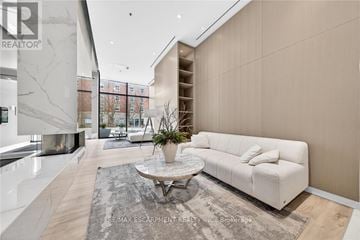 Burlington (Brant) condo for rent - A modern living room with a white sofa and a coffee table.