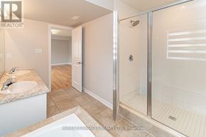 Barrie (Innis-Shore) apartment for rent - A bathroom with a walk-in shower and a sink.
