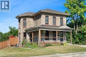 Brantford apartment for rent - A two-story house with a brown roof and a porch.