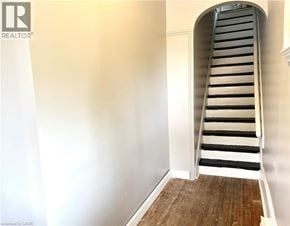 Brantford apartment for rent - A wooden staircase with white risers and black treads.