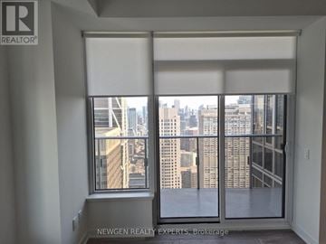 Toronto (Annex) condo for rent - A window with a view of a cityscape.