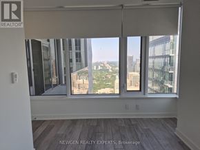 Toronto (Annex) condo for rent - A room with a view of the cityscape through the windows.