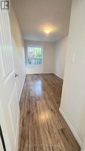Toronto (O'connor-Parkview) apartment for rent - A hallway with wooden floors and white walls.