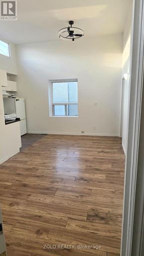 Toronto (O'connor-Parkview) apartment for rent - A room with wooden flooring and a window.