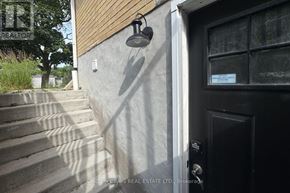 Oshawa (Centennial) apartment for rent - A black door with a glass window and a sign on it.