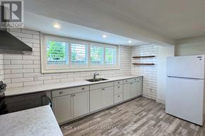 Oshawa (Centennial) apartment for rent - A kitchen with white cabinets and a white fridge.