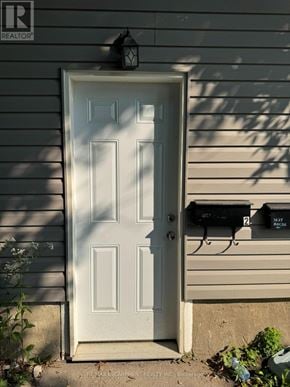 Barrie (Wellington) apartment for rent - A white door with a mailbox on the side of a house.