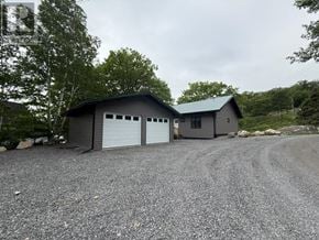 Heyden apartment for rent - A gravel driveway leads to a two-car garage.