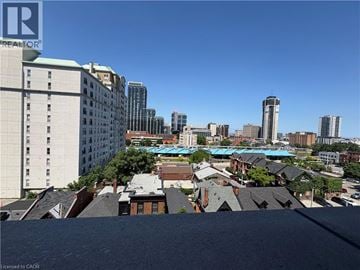 Hamilton apartment for rent - A cityscape with buildings of various heights and a clear blue sky.