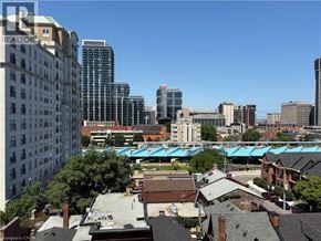 Hamilton apartment for rent - A cityscape with buildings of various heights and a clear blue sky.