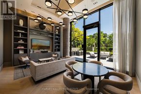Toronto (Forest Hill South) condo for rent - A modern living room with a large couch, a coffee table, and a television.
