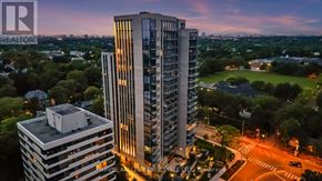 Toronto (Forest Hill South) condo for rent - A tall building with the word REALTOR on it is lit up at dusk.