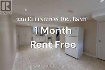 Toronto (Wexford-Maryvale) apartment for rent - A room with a white fridge and a sign that says 1 month rent free.