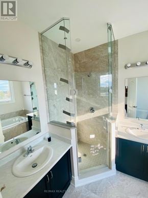 Orillia apartment for rent - A bathroom with a glass shower door and a marble countertop.