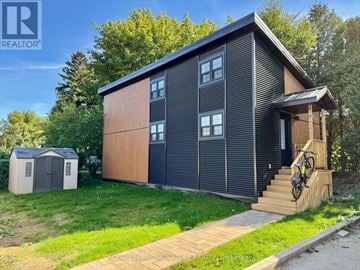 Hamilton (Gilkson) apartment for rent - A modern house with a wooden exterior and a bicycle on the porch.