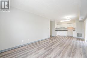 Waterloo multi-family for rent - A spacious living room with wood flooring and white walls.