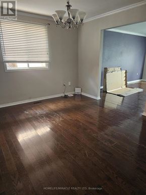 Hamilton (Gilkson) apartment for rent - A room with wooden floors and a chandelier is being renovated.